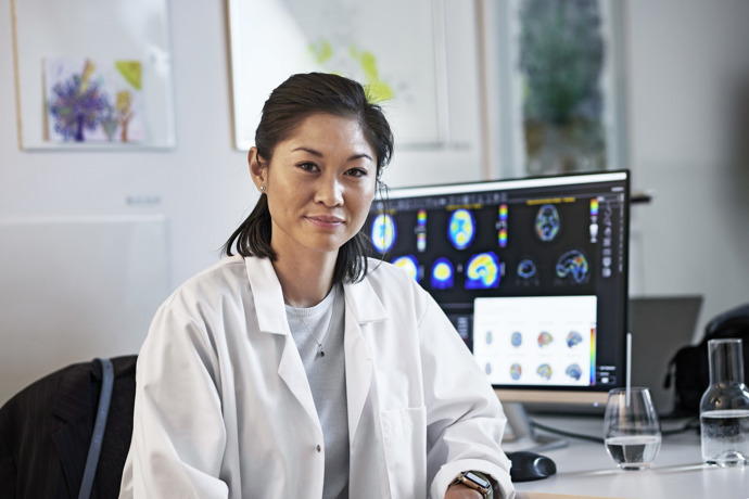 Doctor in front of Hermia workstation showing neurology case.