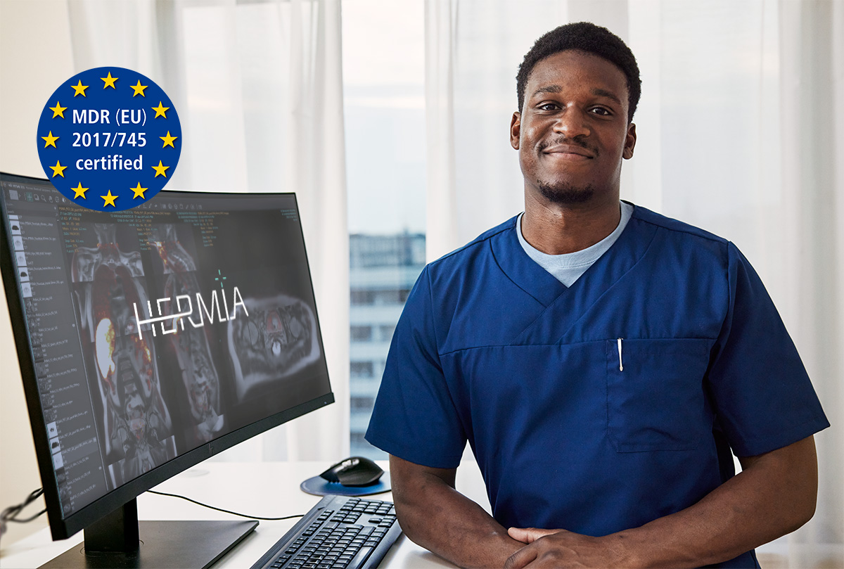 Nuclear medicine technologist in front of a workstation with Hermia software (made for molecular imaging) which is MDR approved